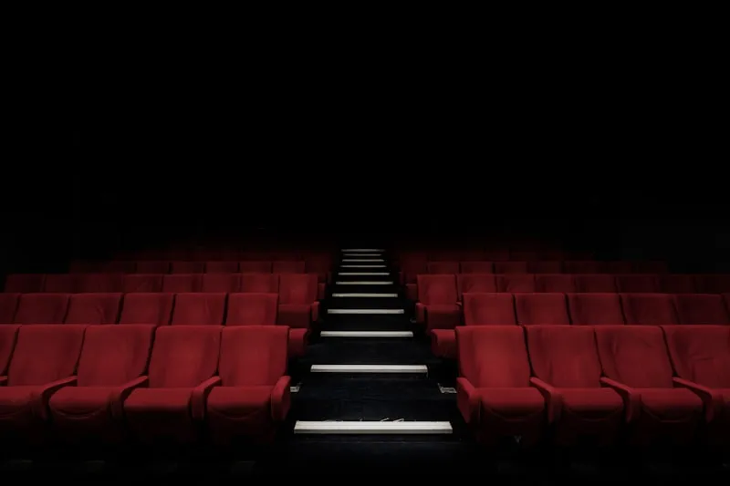 Cinema audience watching a film premiere in a grand theater